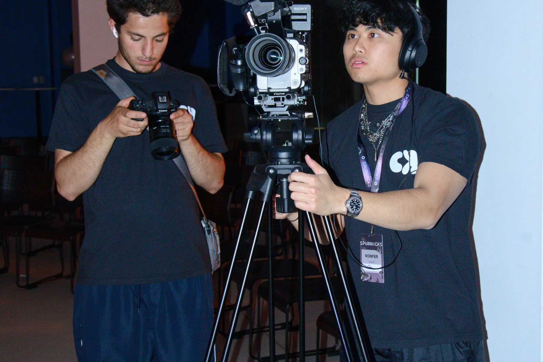 Two CK creators preparing cinema and photography cameras on location