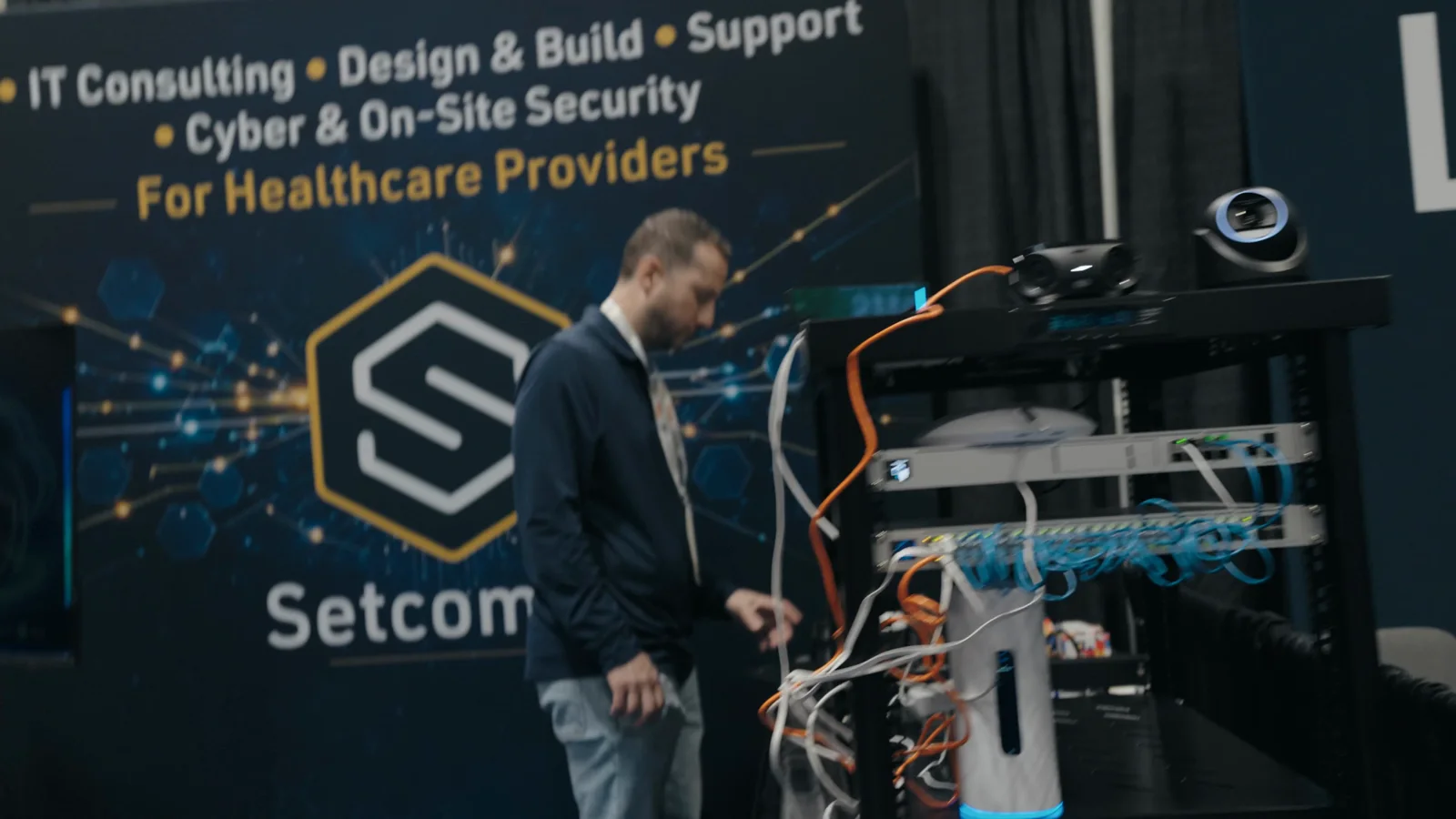 A camera operator covering exhibitors during a professional event
