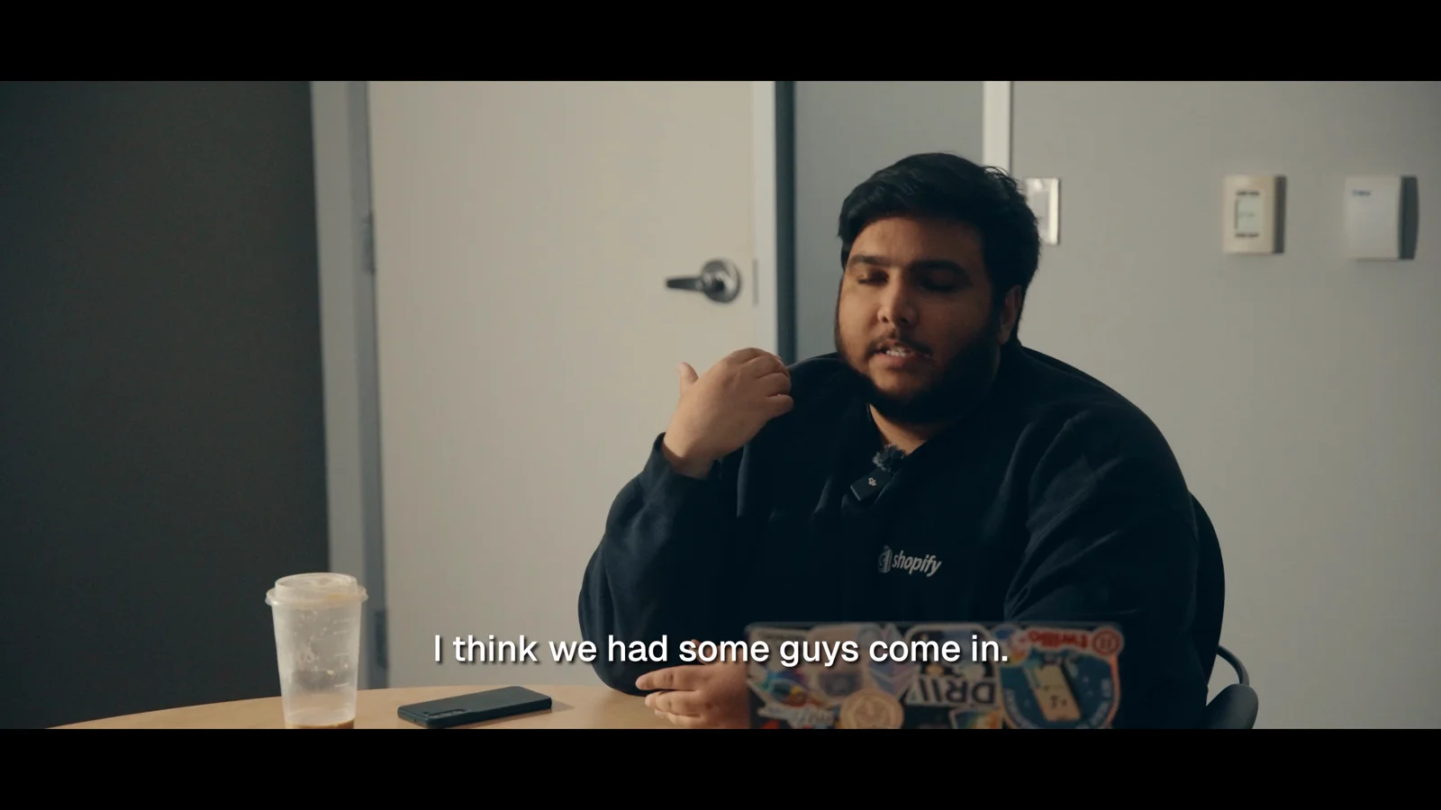 A second interview subject responding in a cinematic setup