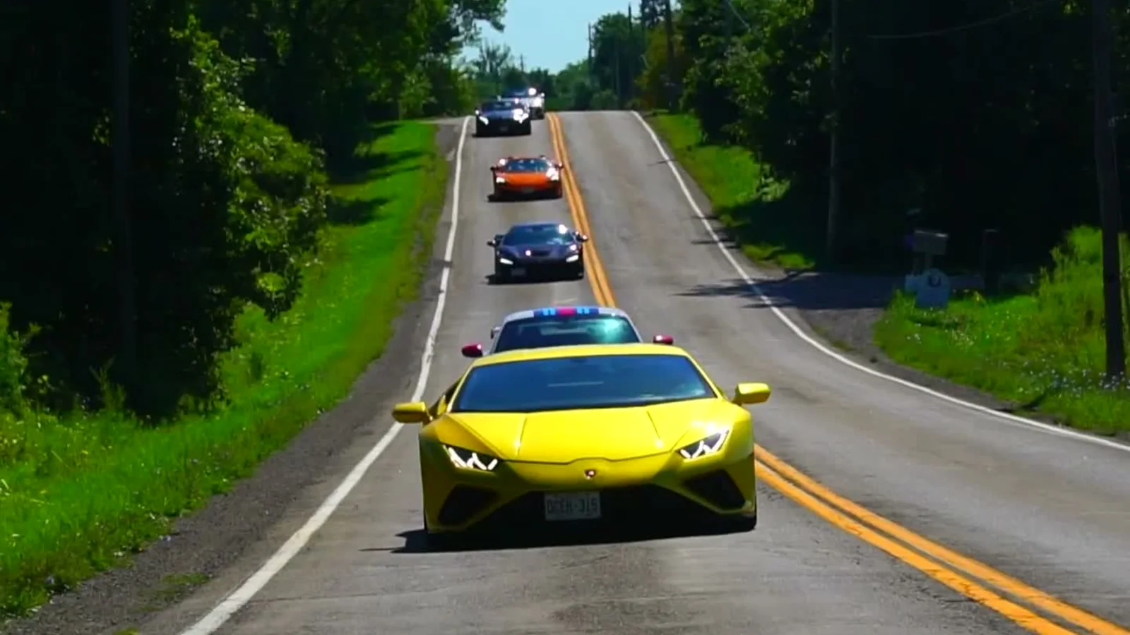 A convoy of performance vehicles driving through Ontario