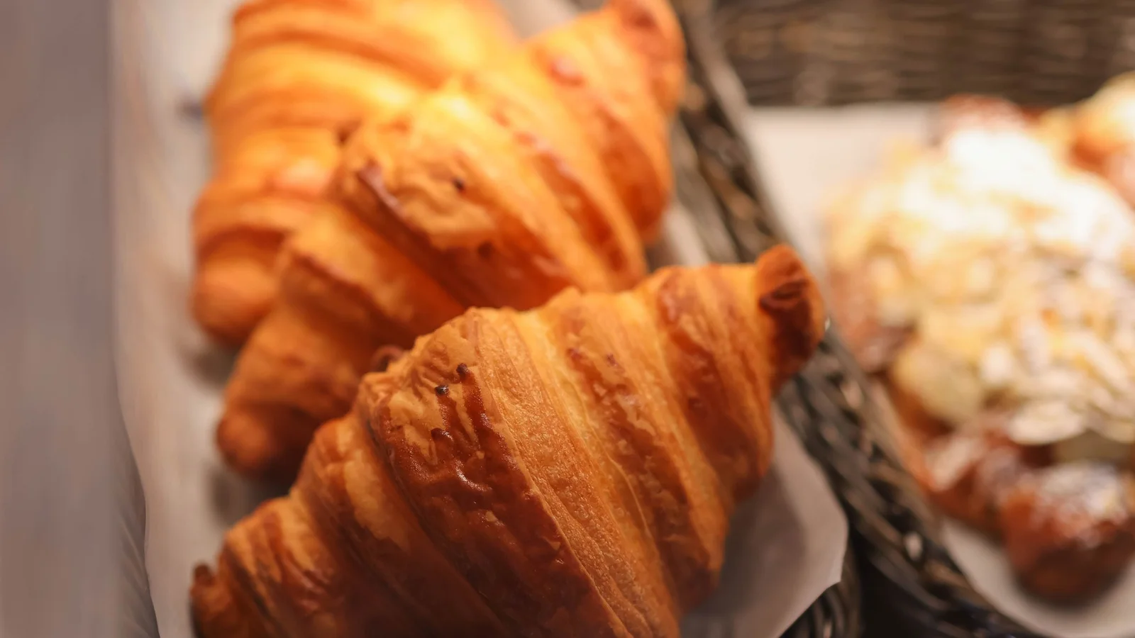 Fresh croissants arranged in a bakery display