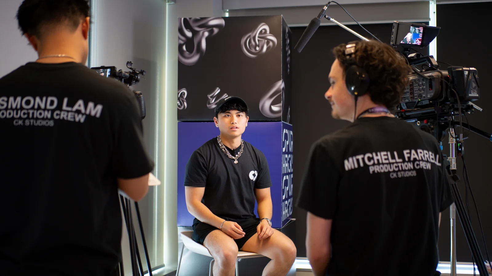 A professional interview being filmed with a full lighting and audio setup