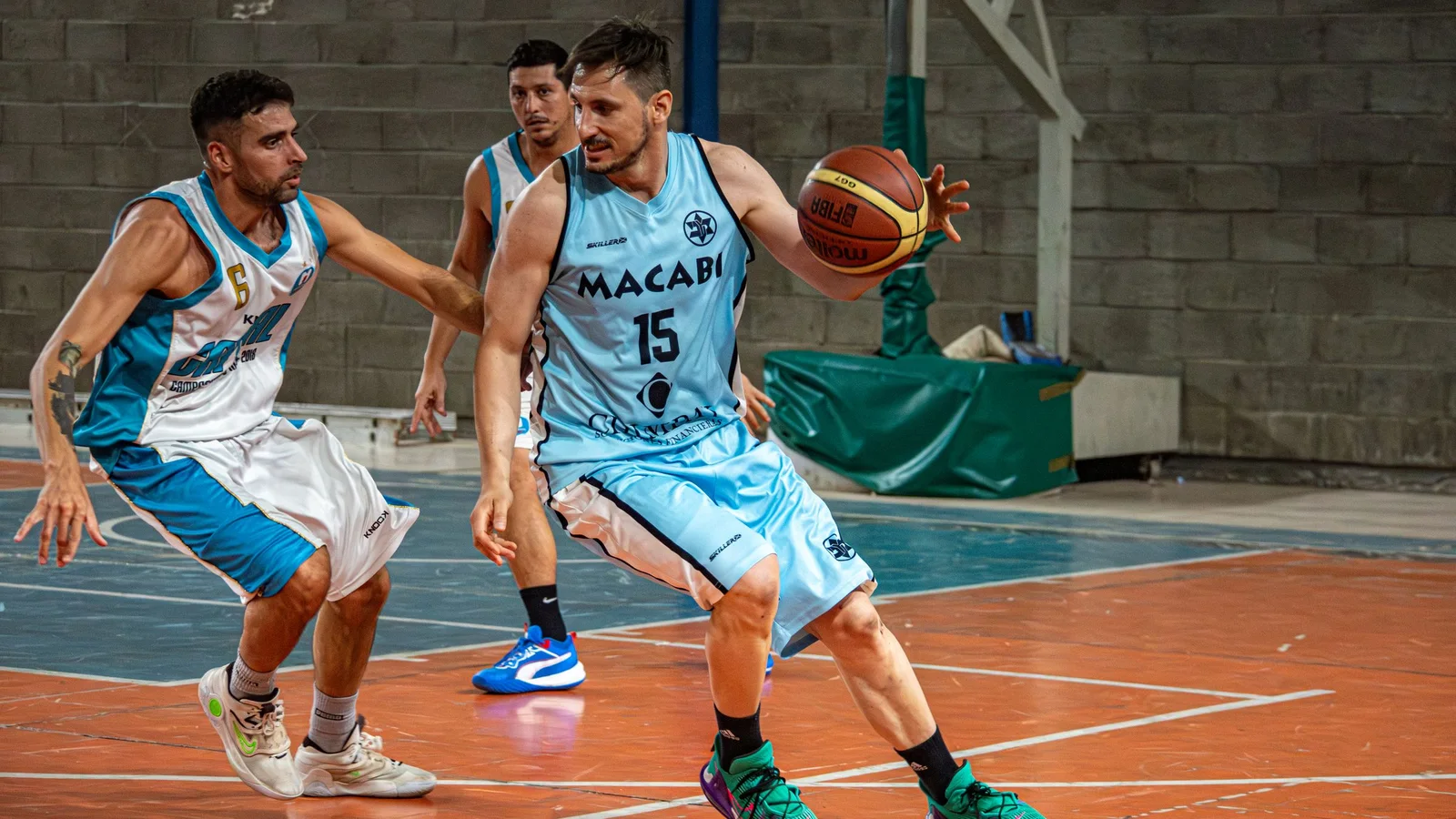 Basketball players competing during an indoor game