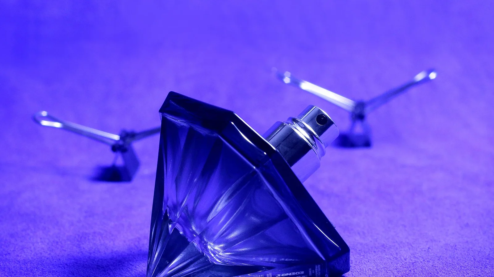 A fragrance product photographed with polished commercial lighting